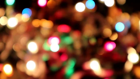 Bokeh effect of blurred holiday lights twinkling in tinsel Video stock 141071446