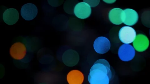 Bokeh effect colorful light balls out of focus / motion background texture black Stock Footage 124603380