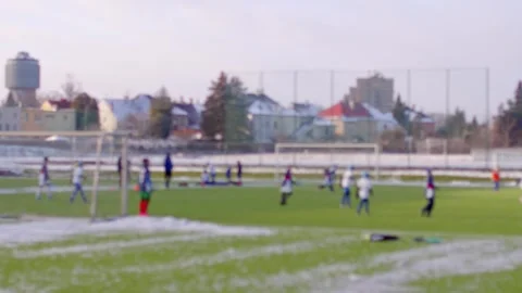 Bokeh effect of interaction between two teams on the field. Snow on the court. Y Stock Footage 295931763