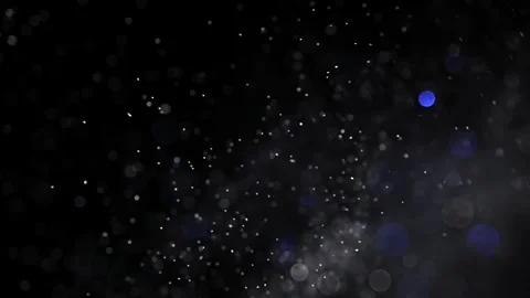 Bokeh effect with white glitter dust and magic particles on a black background. Stock Footage 269707456