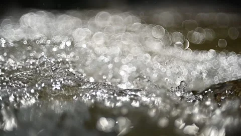 Bokeh effects from sunlight on the water from a mountain stream (slow motion) Stock-Footage 219640411