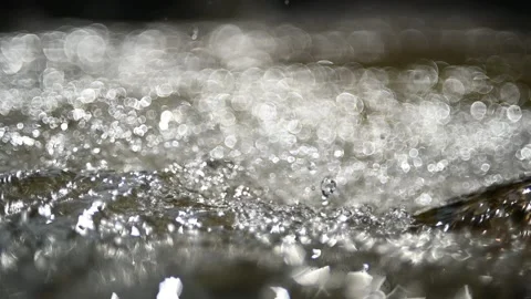 Bokeh effects from sunlight on the water from a mountain stream 스톡 동영상 219640549