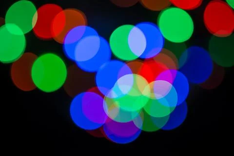 Bokeh light circles background. Defocused Christmas lights in RGB colors Stock Photos