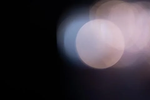 Bokeh light circles glowing on dark background Stock Photos