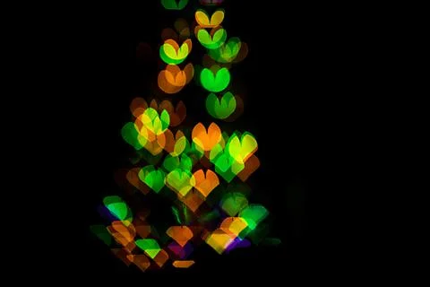 Bokeh of light in the form of bright colored hearts Stock Photos