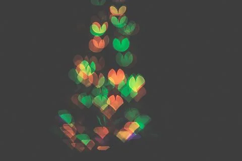 Bokeh of light in the form of bright colored hearts Stock Photos