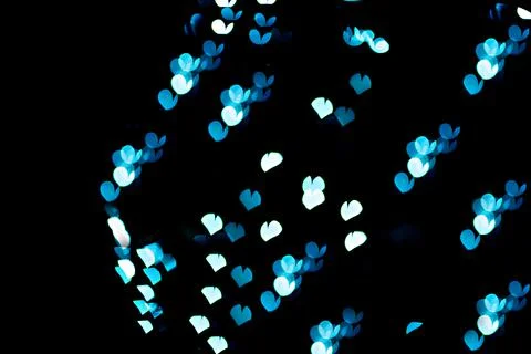 Bokeh of light in the form of bright colored hearts Stock Photos