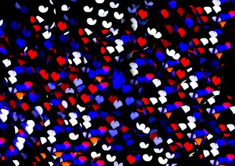 Bokeh of light in the form of bright colored hearts Stock Photos