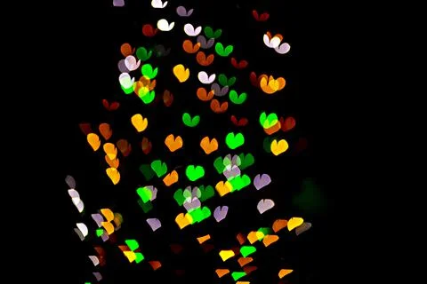 Bokeh of light in the form of bright colored hearts Stock Photos