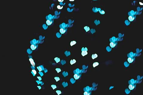 Bokeh of light in the form of bright colored hearts Stock Photos