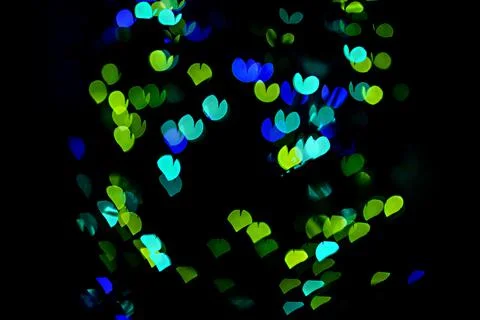 Bokeh of light in the form of bright colored hearts Stock Photos