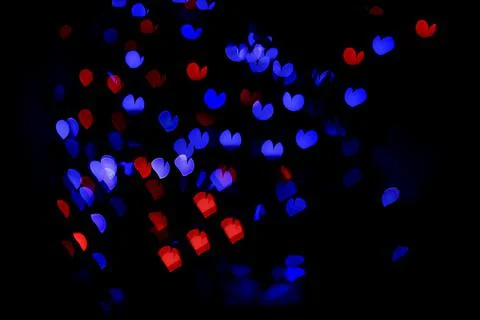 Bokeh of light in the form of bright colored hearts Stock Photos
