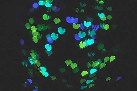 Bokeh of light in the form of bright colored hearts Stock Photos