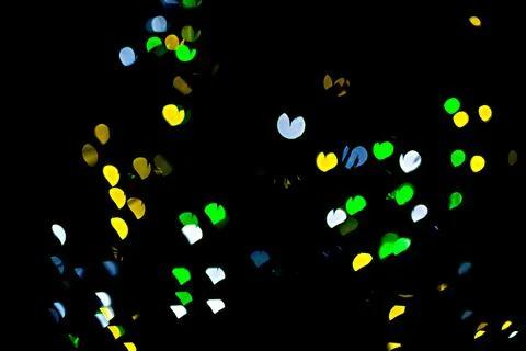 Bokeh of light in the form of bright colored hearts Stock Photos