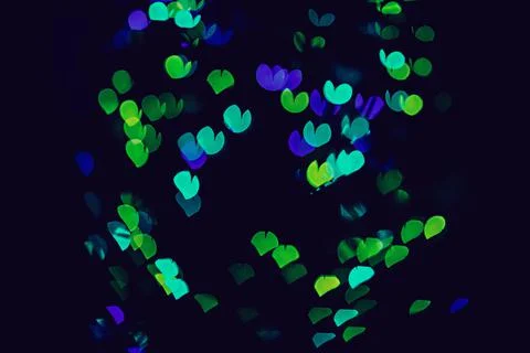 Bokeh of light in the form of bright colored hearts Stock Photos