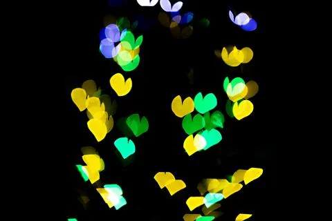 Bokeh of light in the form of bright colored hearts Stock Photos