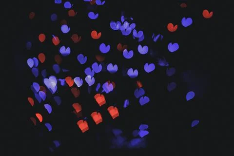 Bokeh of light in the form of bright colored hearts Stock Photos