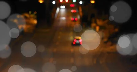 Bokeh light image over blurred night street scene with traffic lights Fotos Stock