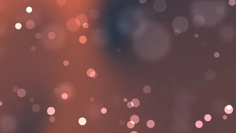Bokeh lights glowing in warm orange and pink tones against dark background Video stock 335944086