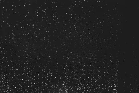 Bokeh of lights made by raindrops on a windows illuminated by a torch Stock Photos