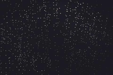 Bokeh of lights made by raindrops on a windows illuminated by a torch Stock Photos