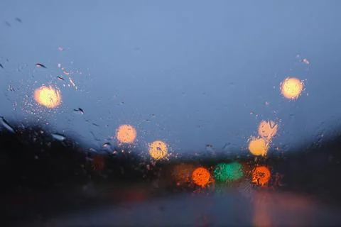 Bokeh lights seen through a window on a rainy day Stock Photos