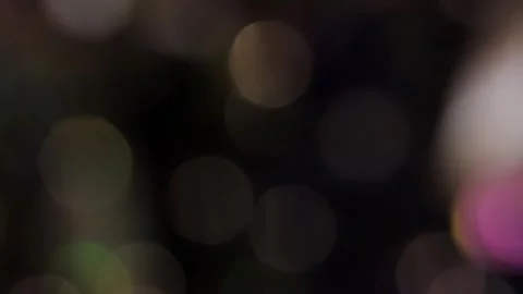 Bokeh overlay in the form of a blurred, flickering color video on a black backgr Stock Footage 317478831