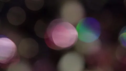 Bokeh overlay in the form of flashing colored video on a black background Video stock 317479241