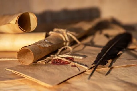 Bokeh. Part of an ancient paper scroll, close-up, illuminated by a sunbeam. T Stock Photos