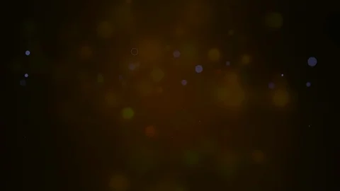 Bokeh particles float and glisten over dark background with depth of field. Stock Footage 123283214