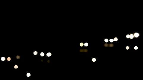 Bokeh shot of Heavy traffic flowing on a road at night Stock Footage 135258448