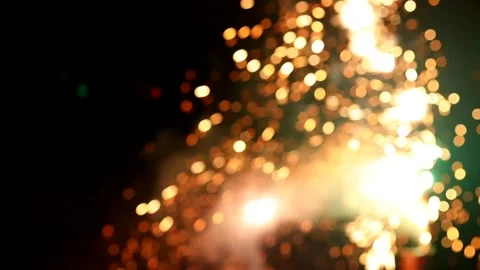 Bokeh sparks flying as firework burns in background 動画素材 146820451