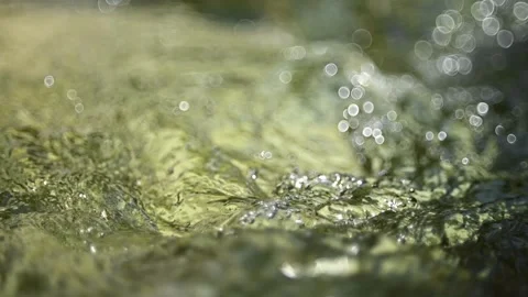 Bokeh from a standing wave from a mountain stream in sunlight (slow motion) Stock-Footage 262091858
