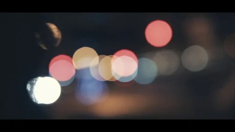 Bokeh of the streetlights in a car while waiting for the light to turn green Stock Footage 78526934