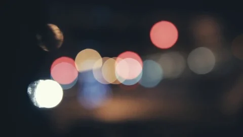 Bokeh of the streetlights in a car while waiting for the light to turn green Stock Footage 78557745