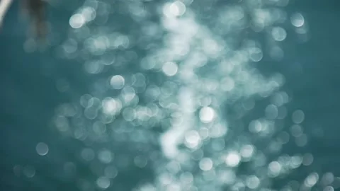 Bokeh Sun glare bouncing off a jet of water Vídeos de archivo 159367055