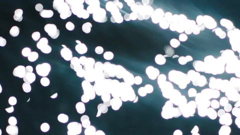 Bokeh sun glare reflected in water surface. Sunrays flickering in water stream.  Stock Footage 122907142