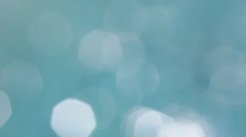 Bokeh of the sun glares reflected from blue water Stock Footage 23004567