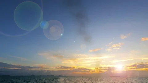 Bokeh sun light ray n sunbeam lens flare on golden sunset blue sky Stock Footage 161221776