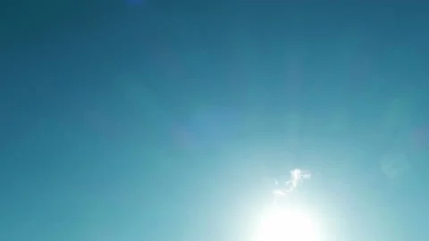 Bokeh sun light ray n rainbow spectrum lens flare on cyan blue sky Stock Footage 172124545