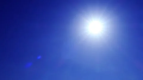 Bokeh sun light ray n lens flare sunlight beam on sunny clear deep blue sky Stock Footage 242158685