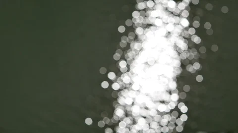 Bokeh of sun reflections sparkling and shining on water surface Stock Footage 103492277