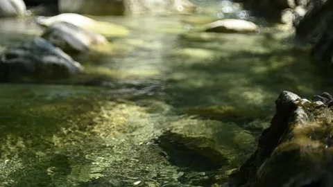 Bokeh of sunlight effects on a mountain stream in summer (slow motion) Stock-Footage 262089653