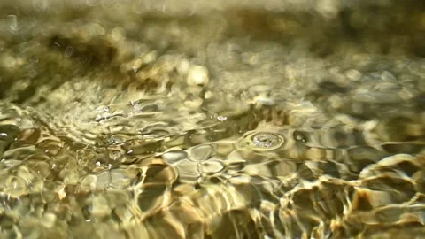 Bokeh of sunlight effects on the water in a mountain riverbed (slow motion) Video stock 211747293