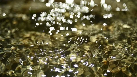 Bokeh of sunlight reflections on the water in a mountain riverbed (slow motion) Stock-Footage 211746635
