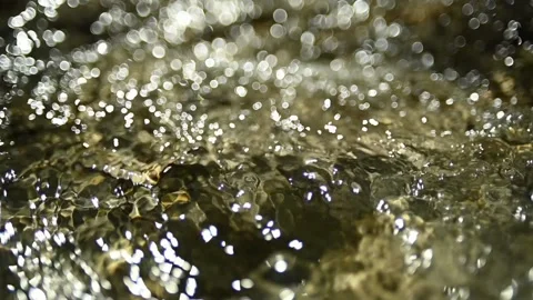 Bokeh of sunlight reflections on the water in a mountain riverbed (slow motion) Stock-Footage 211746722