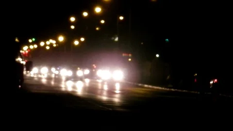 Bokeh traffic lights during the night. Colorful blurred car headlights Stock Footage 82807879
