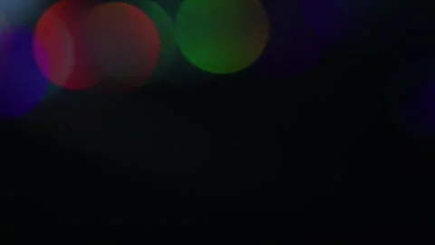 Bokeh video of colored lights pointing upwards horizontally 스톡 동영상 309488097