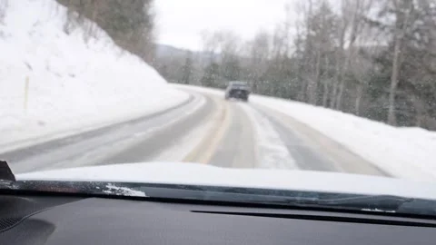 Bokeh video hand held shaky cam driving car in snow mountain road Stock Footage 262378619