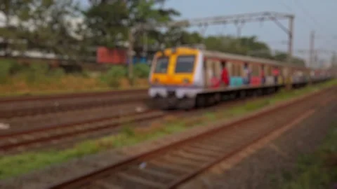 Bokeh view outside of moving suburban passenger train running to Mumbai, India. Stock Footage 311773877